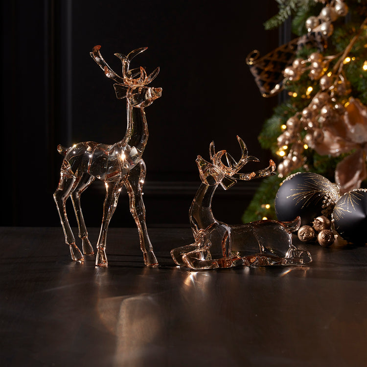 Two acrylic deer figurines with gold accents