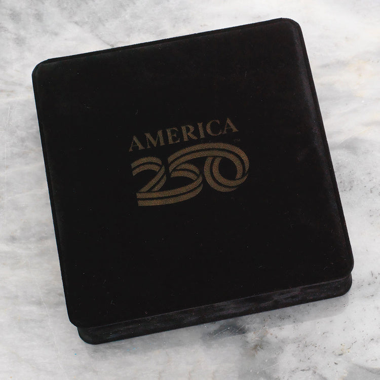 Black velvet box with 'America 250' text on a marble surface
