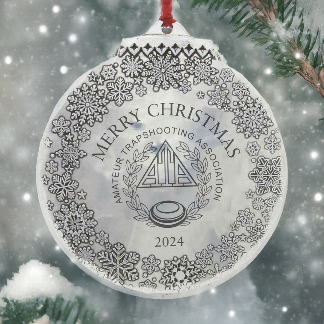 Decorative Christmas ornament with 'Merry Christmas' text and snowflake patterns, set against a snowy background.