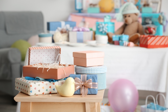 Baby shower gifts piled up at a party