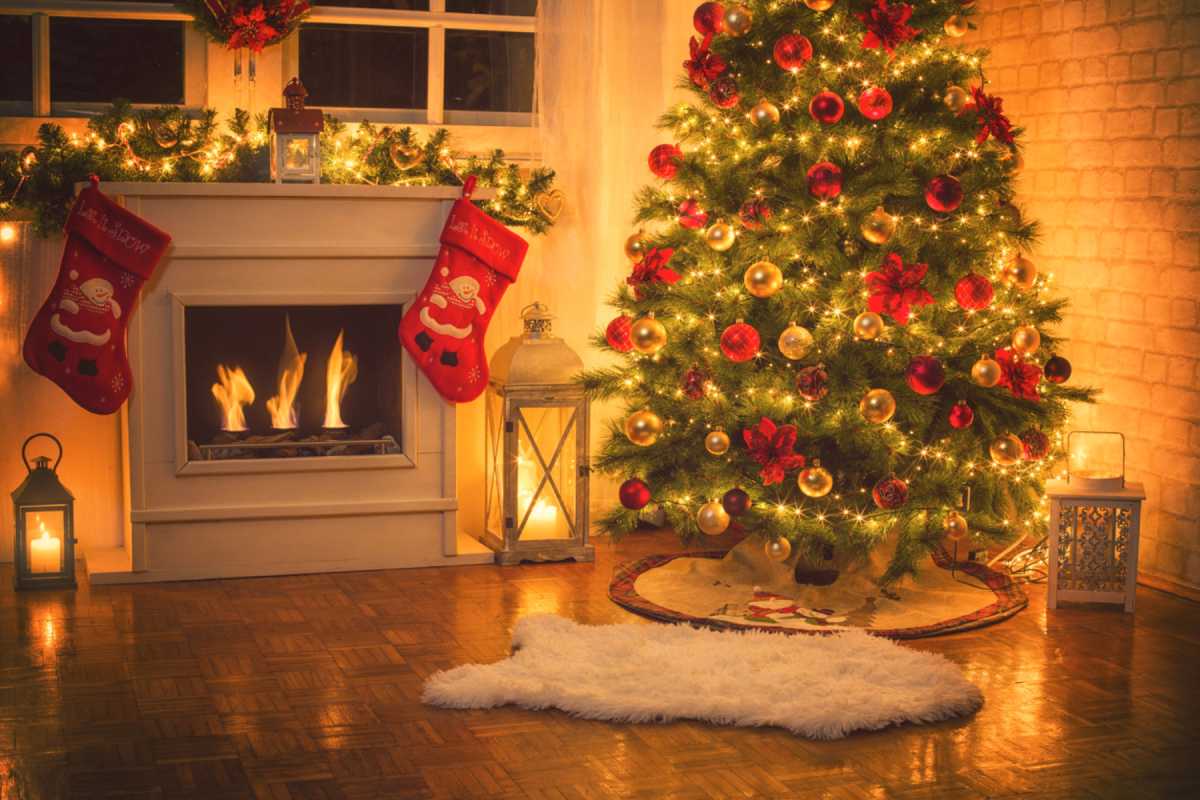 Christmas tree with ornaments in front of fire 