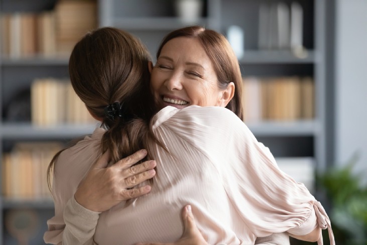 Close up of two women sharing an embrace